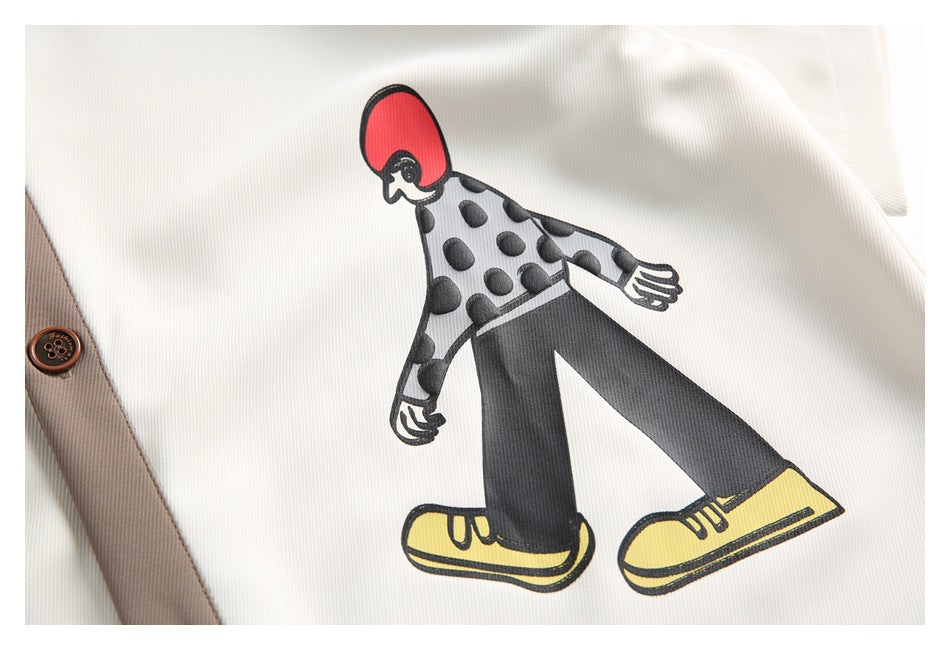 Close-up of a printed figure in a gray polka-dot top, black trousers, and yellow shoes.