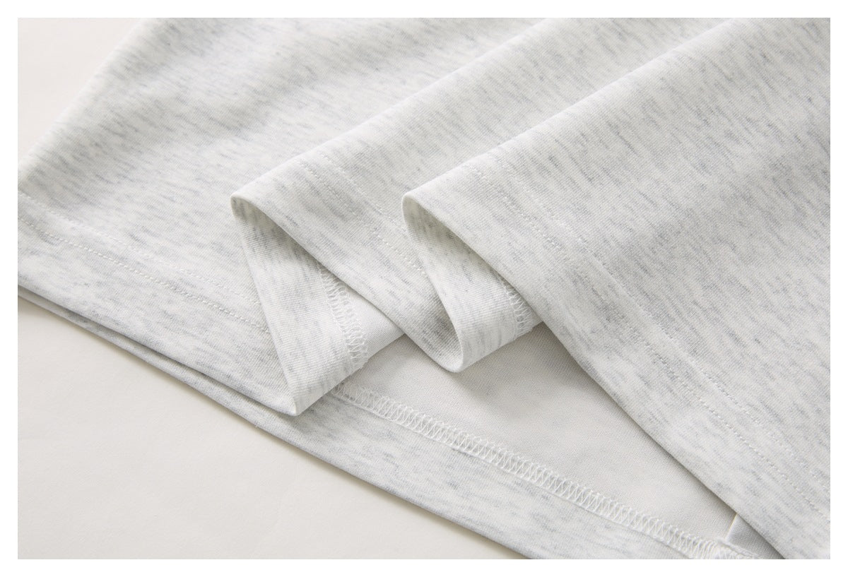 Close-up of the light gray heather polo shirt’s folded sleeve and stitched hem.