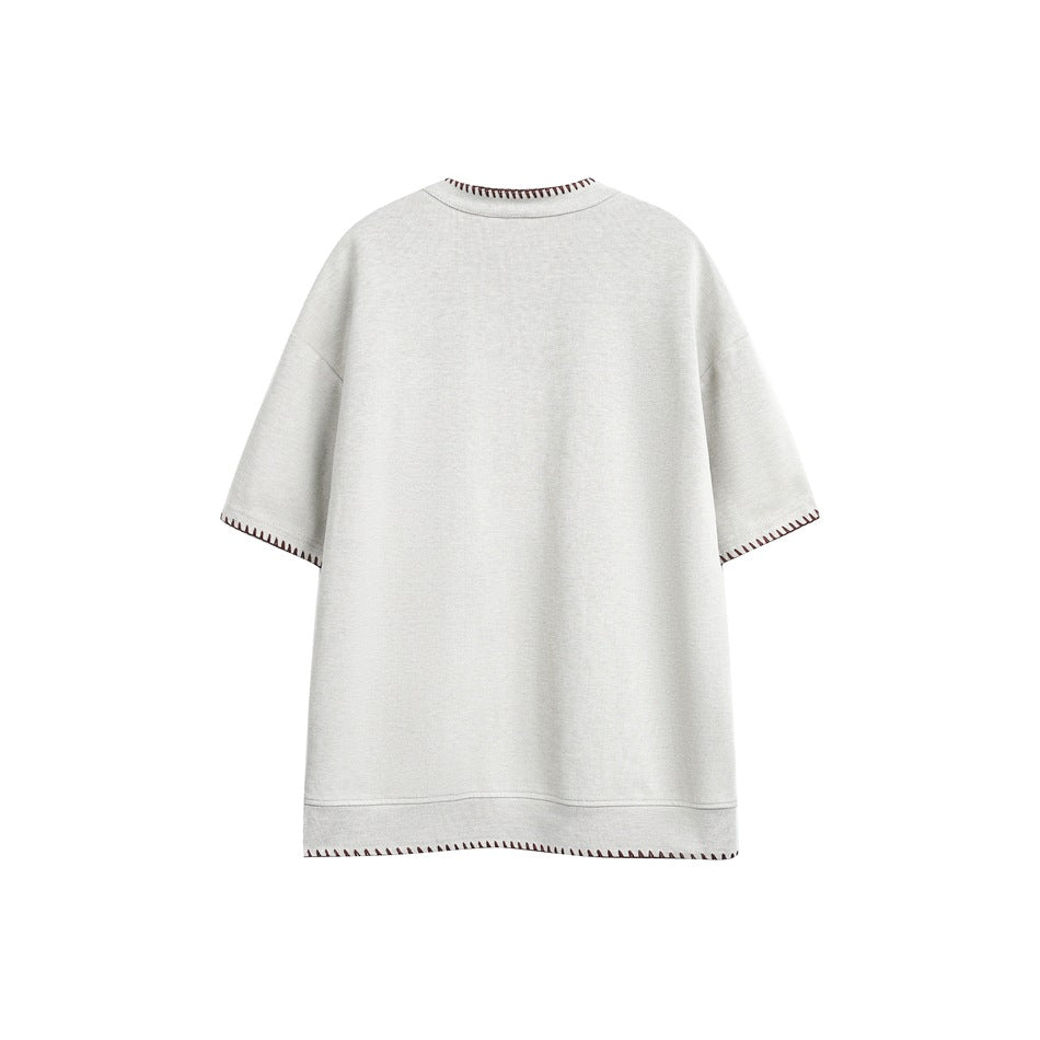 Back view of a light gray short-sleeve shirt with dark reddish contrast stitching at the collar, cuffs and hem.