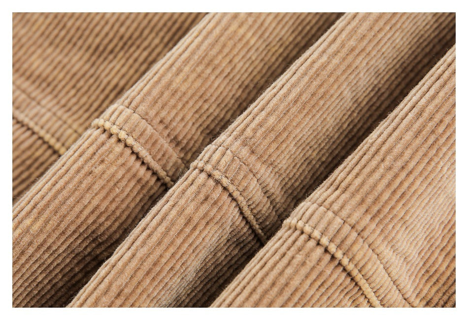 Close-up of stitched seams and edges on tan corduroy garment panels.