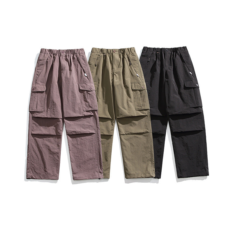 Three cargo pants displayed together in mauve, olive, and black colorways.