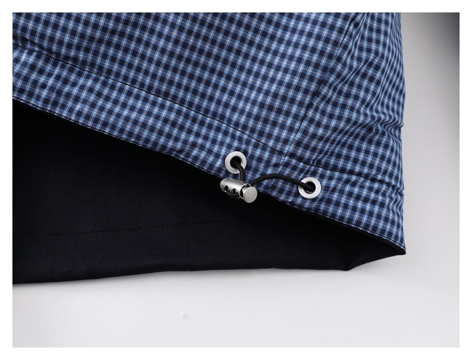 Close-up of the jacket hem showing a black drawcord, eyelets, and toggle.