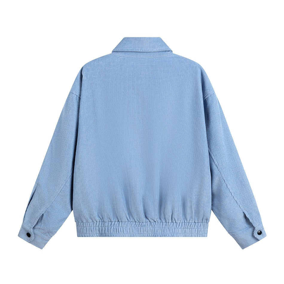 Back of a light blue collared jacket displayed flat, with long sleeves, buttoned cuffs, and an elasticized hem.