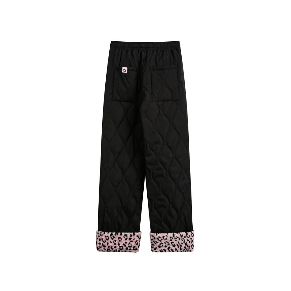 Back view of black quilted pants with two rear pockets and pink leopard-print cuffs, shown against a white background.