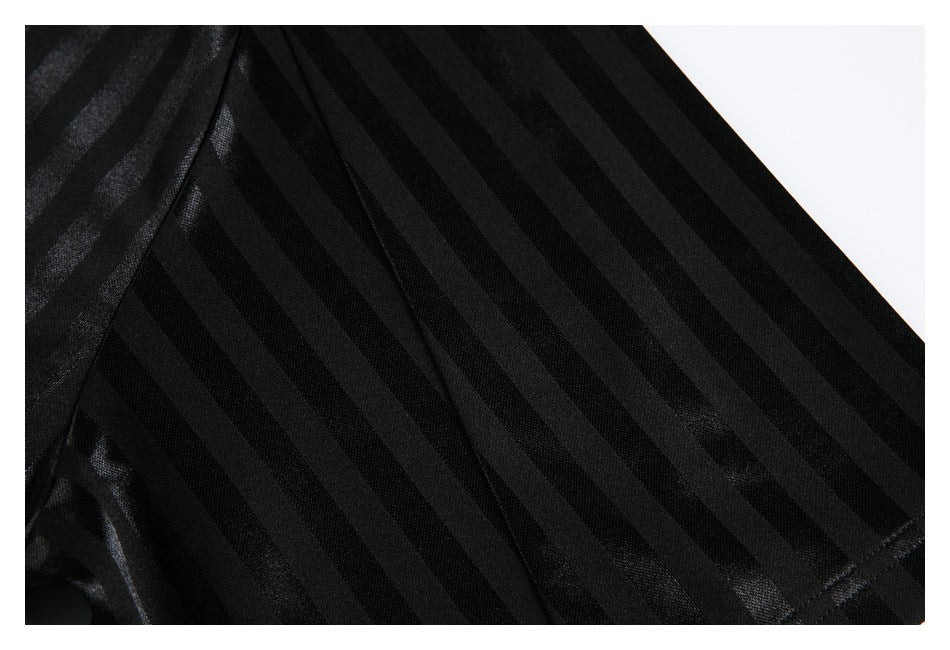 Close-up of a black sleeve with alternating subtle stripes and a stitched seam.