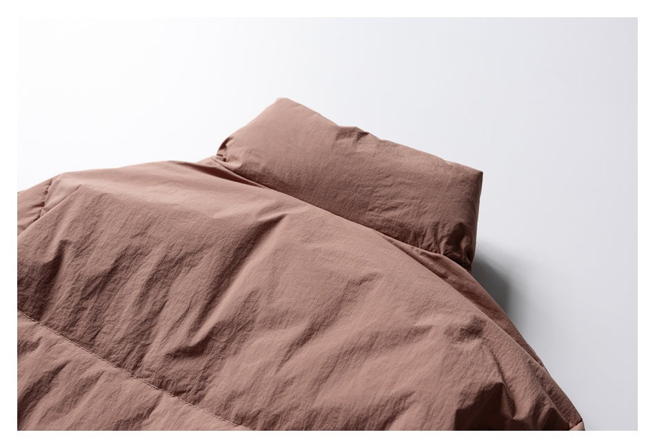 Close-up of a brown garment’s broad fabric panel and raised folded section.