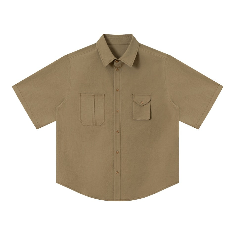 Olive-tan green short-sleeve work shirt flat lay, front view with two different chest pockets and buttons