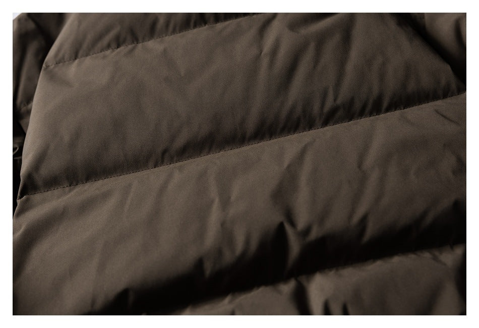 Close-up of dark brown padded jacket with wide horizontal stitched sections.