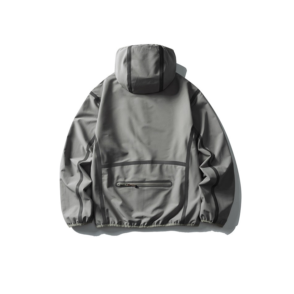 Back view of a gray hooded jacket with dark contrast seam trim and a horizontal zip pocket.
