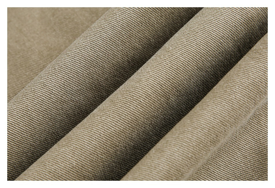 Close-up of beige-brown fabric with a fine diagonal ribbed weave.
