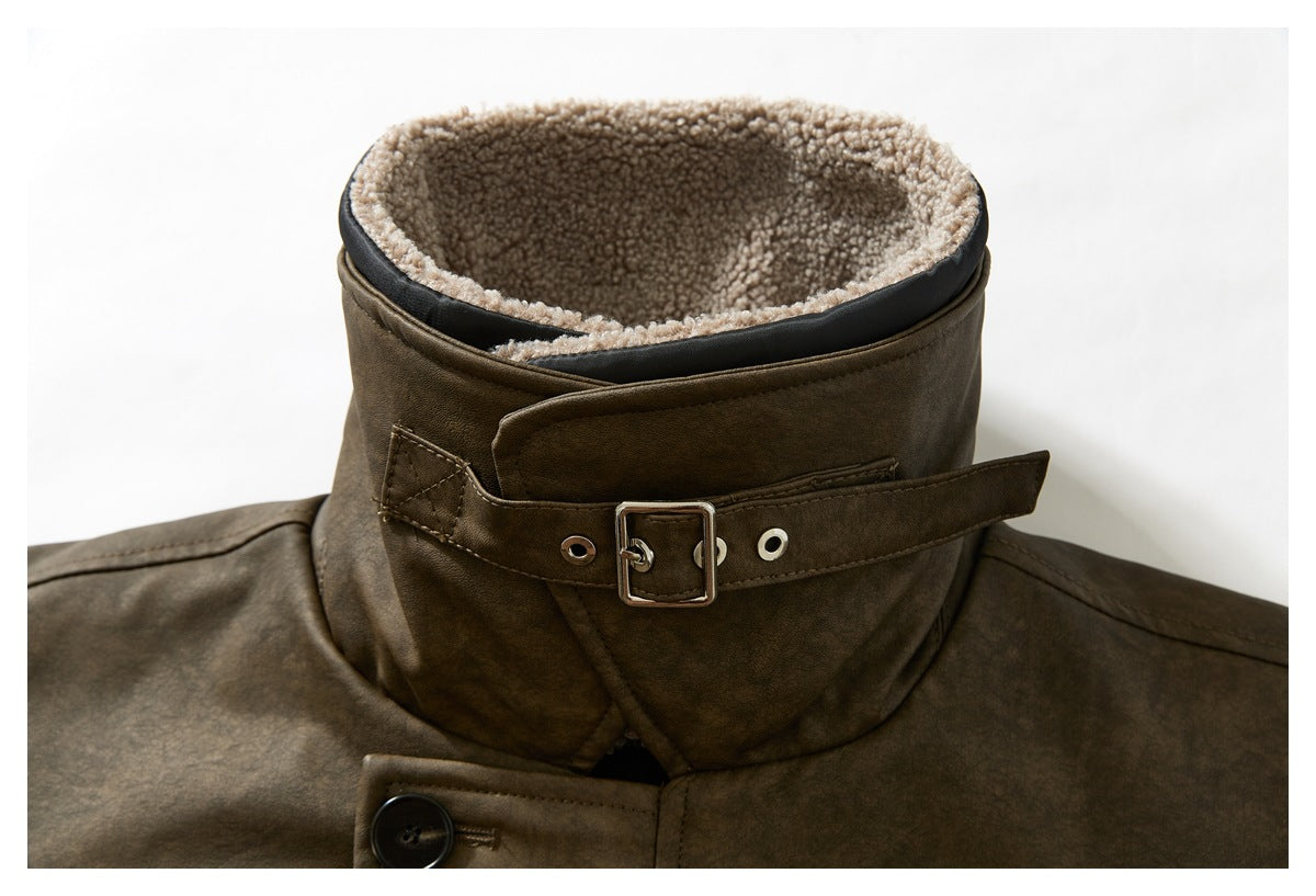 Close-up of a brown jacket’s tall collar, showing cream fleece lining and a buckle strap.