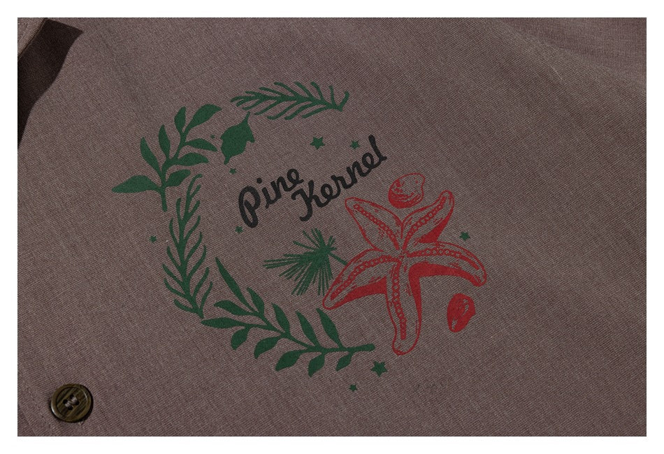 Close-up of the taupe shirt's green foliage and red starfish chest graphic.