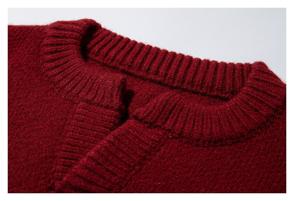 Close-up of a burgundy sweater's ribbed collar and neckline.