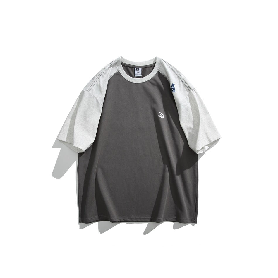 Front view of a charcoal gray T-shirt with light heather-gray raglan sleeves and a small white chest emblem.