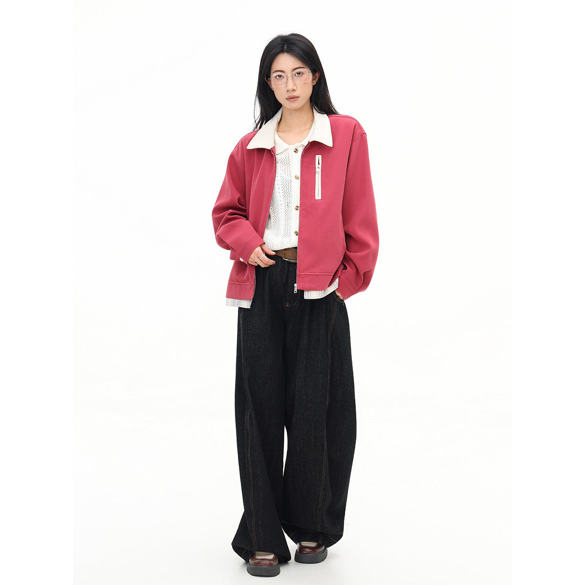 Full-length model wearing an open rose-pink jacket with a cream collar, over a white top and wide-leg black jeans.