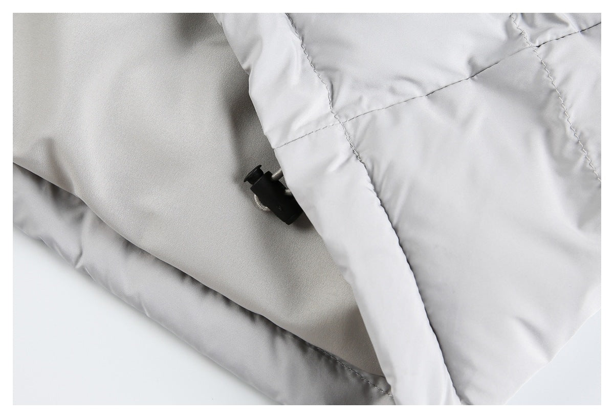 Close-up of the light gray jacket's inner lining and a small black adjustment toggle.