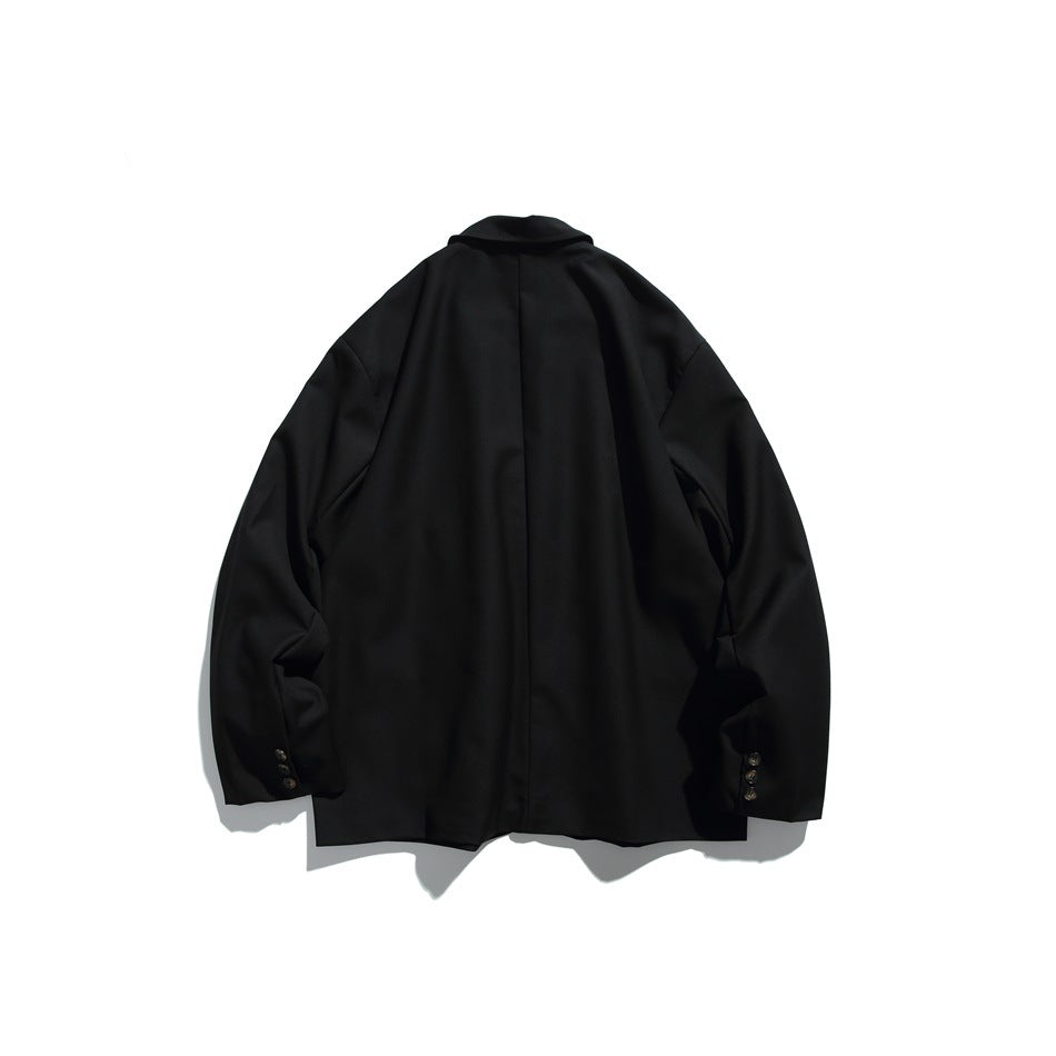 Black blazer shown from the back, with a center seam, long sleeves, and buttons at the cuffs on a white background.
