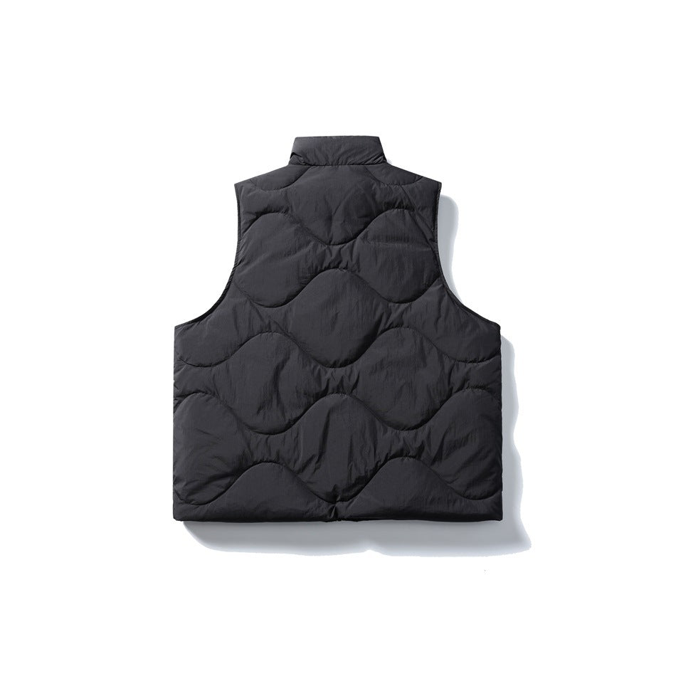 Back view of black puffer vest with large wavy quilted pattern and stand collar