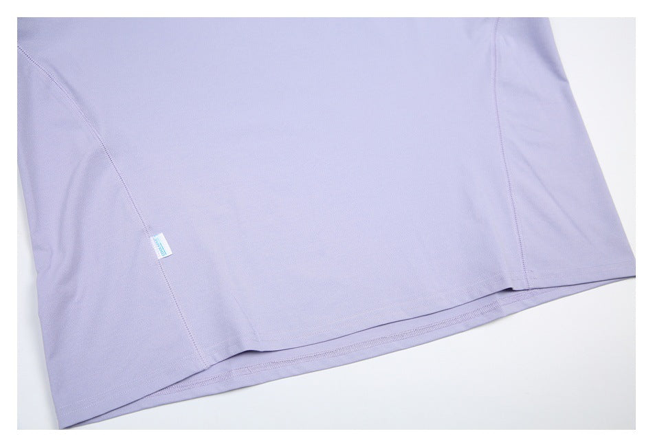 Partial flat lay of a lavender garment showing panel seams, hem stitching, and a small COOLMAX label.