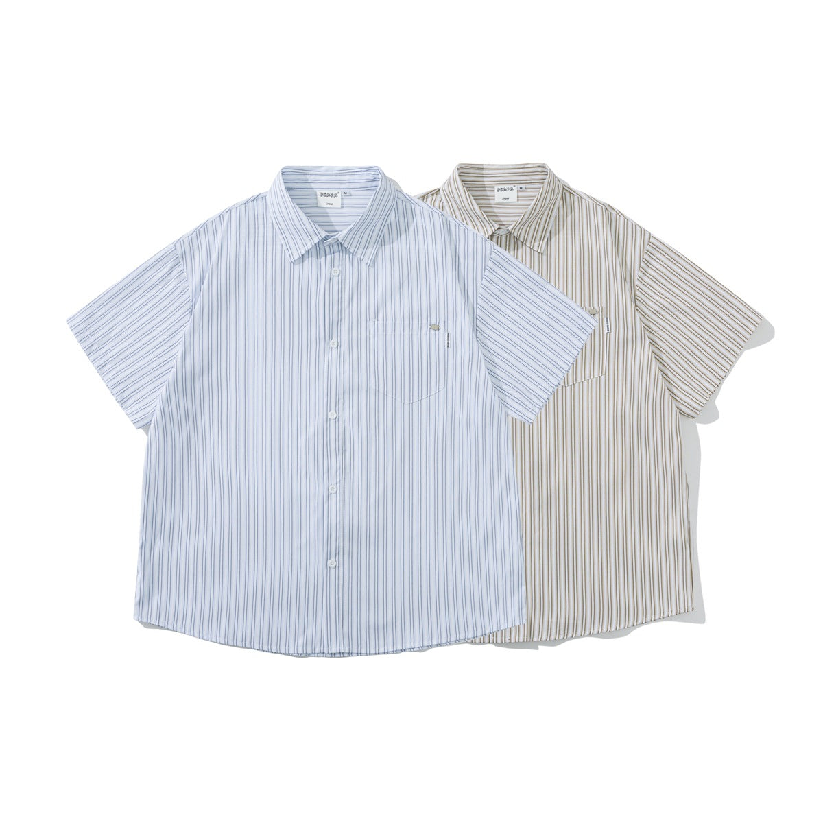 Two short-sleeve button-up shirts displayed front-facing: one white with blue stripes and one white with tan stripes.