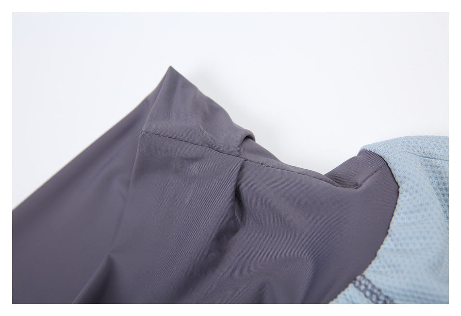 Close-up of a charcoal-gray panel seam where it joins light blue textured fabric.