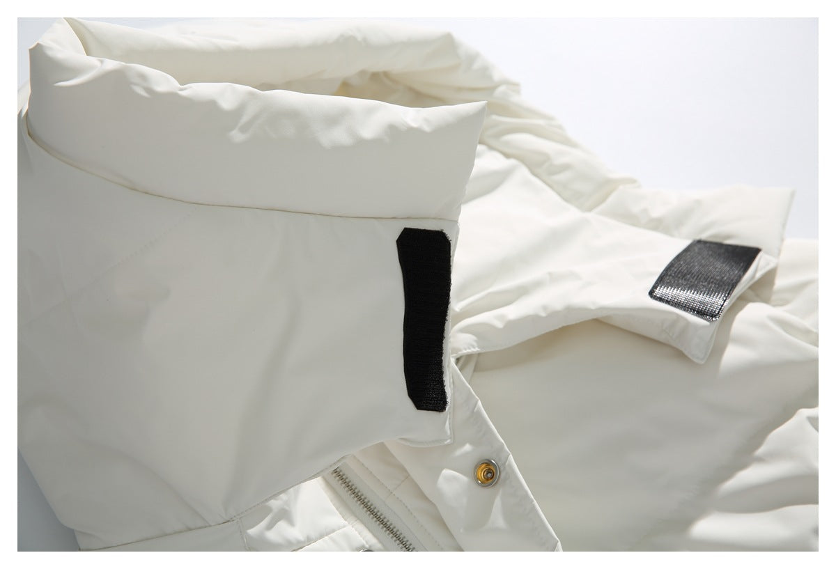 Close-up of the ivory jacket's sleeve cuff with black hook-and-loop fastening tabs.