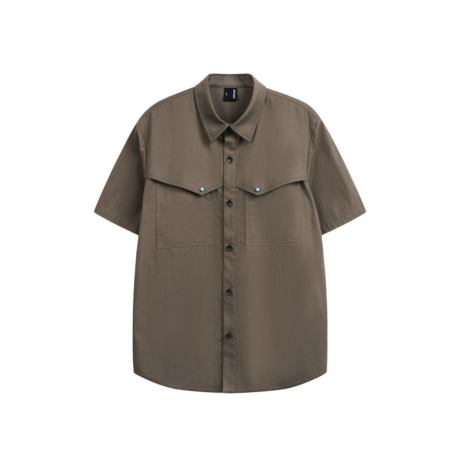 Brown short-sleeve button-up shirt with two large chest flap pockets and turquoise studs, front view on white