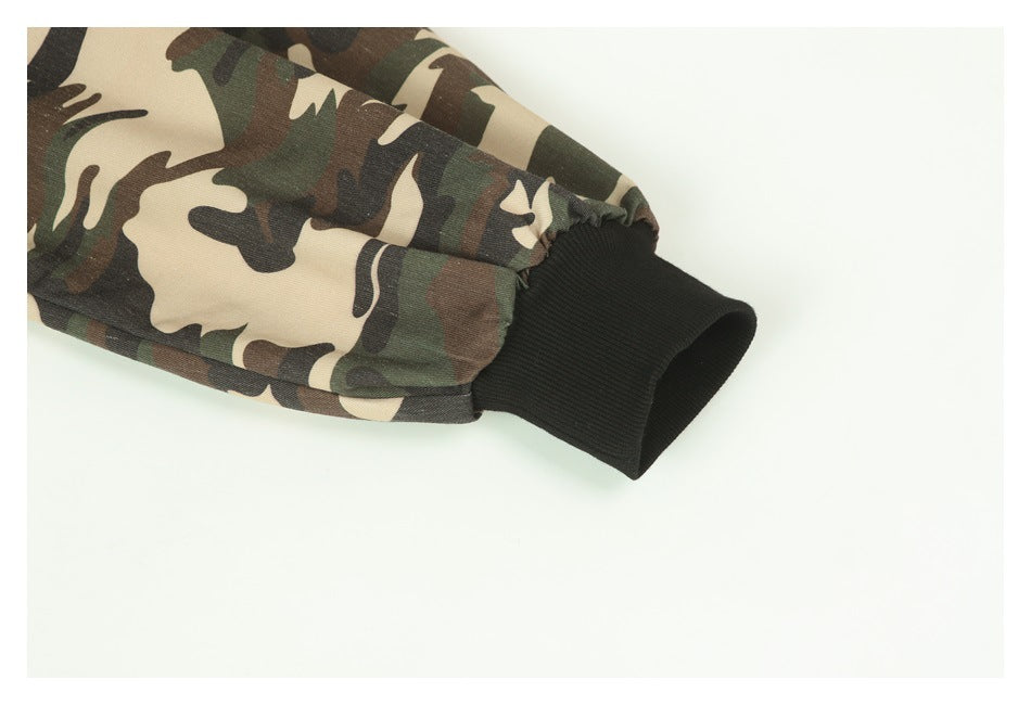 Close-up of a camouflage sleeve ending in a wide black ribbed cuff.