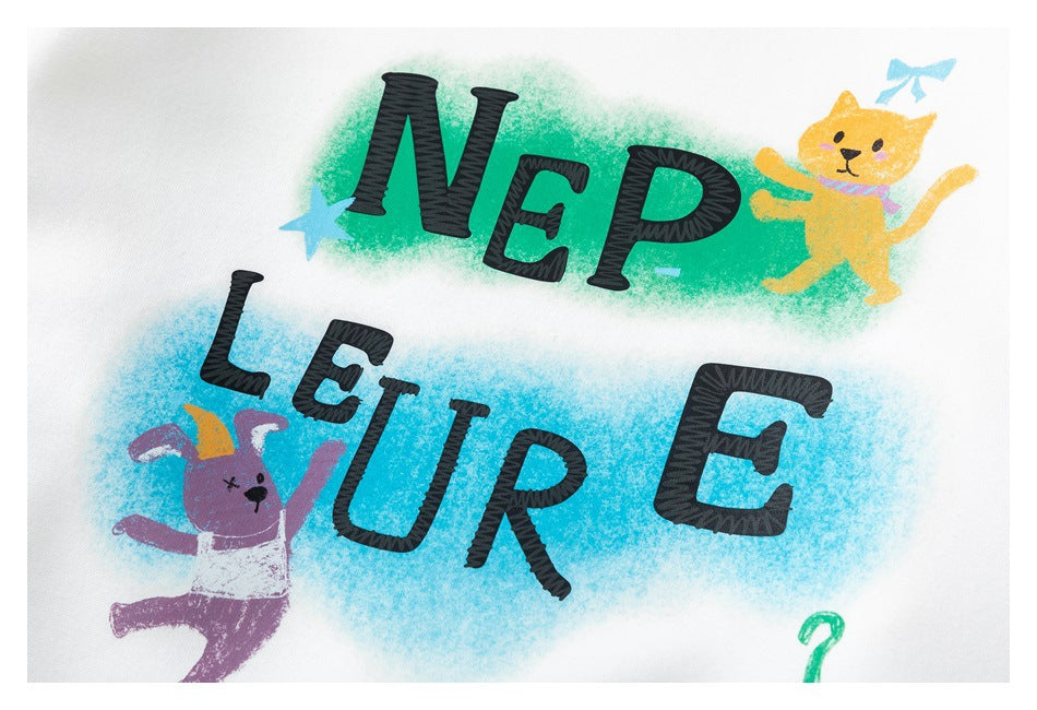 Close-up of colorful animal illustrations and bold black lettering printed on a white sweatshirt.