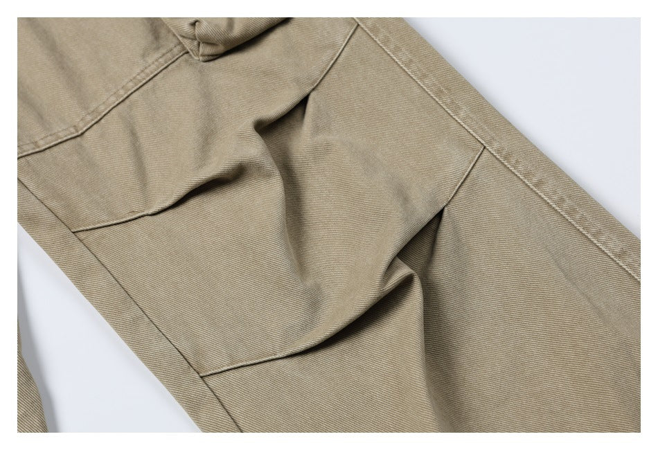 Close-up of a khaki pant leg with curved panel seams and a partial cargo pocket.