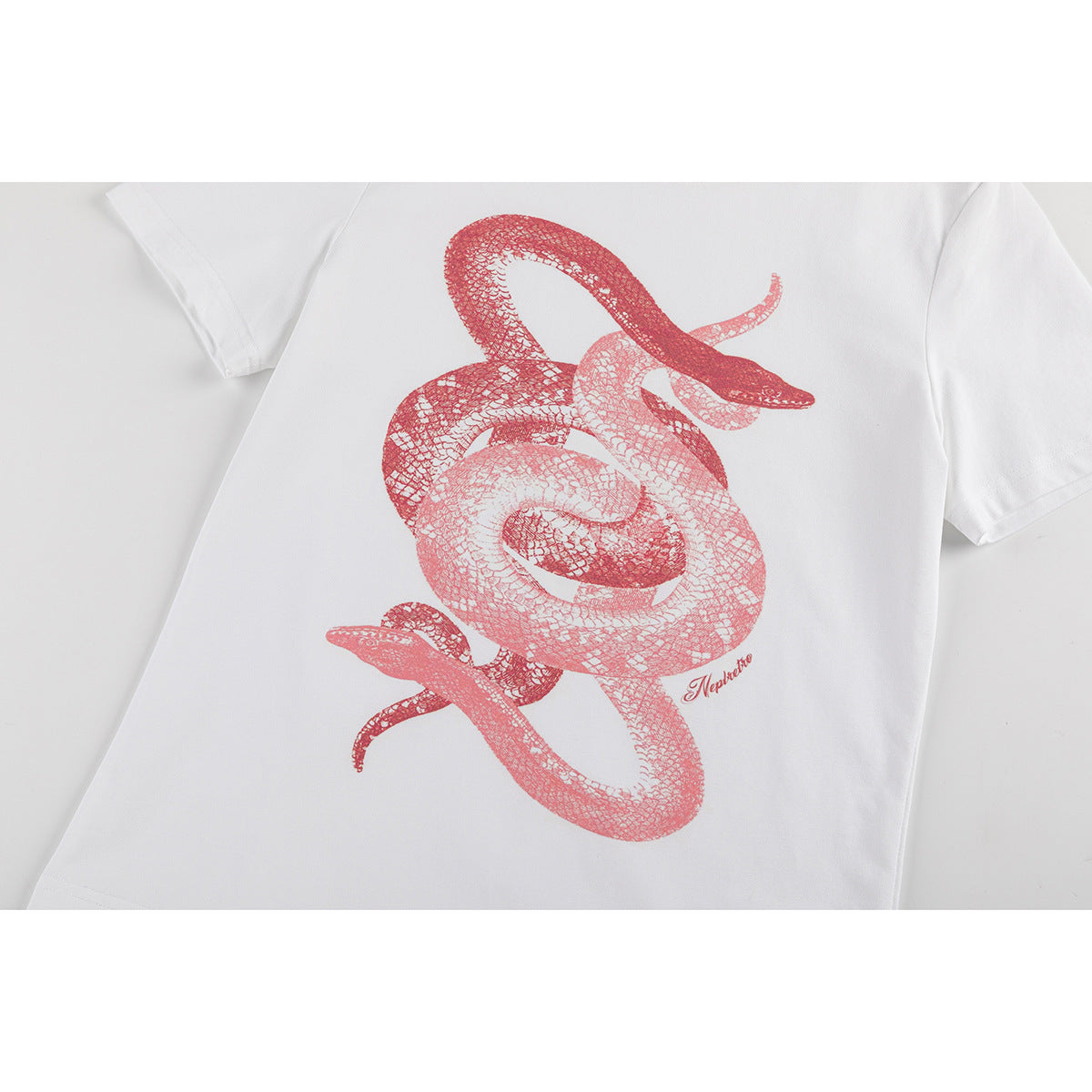 Close view of a white short-sleeve T-shirt with a large red illustration of intertwined snakes.
