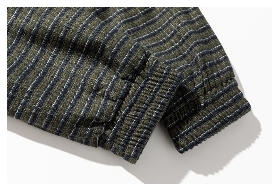 Close-up of a dark striped garment showing a ribbed cuff and stitched seam.