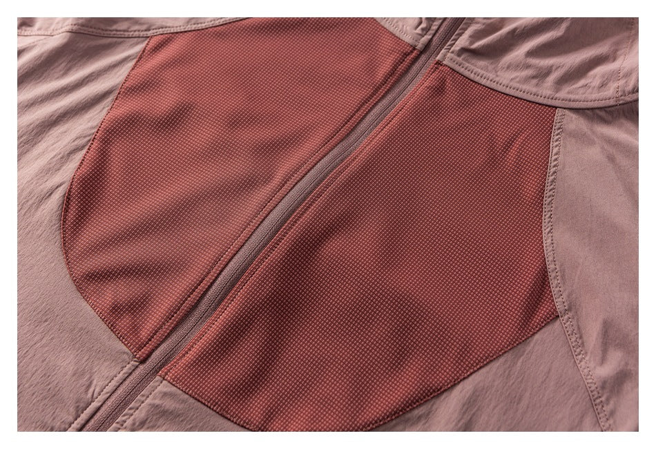 Close-up of a mauve garment with a central zipper and contrasting textured reddish panels.