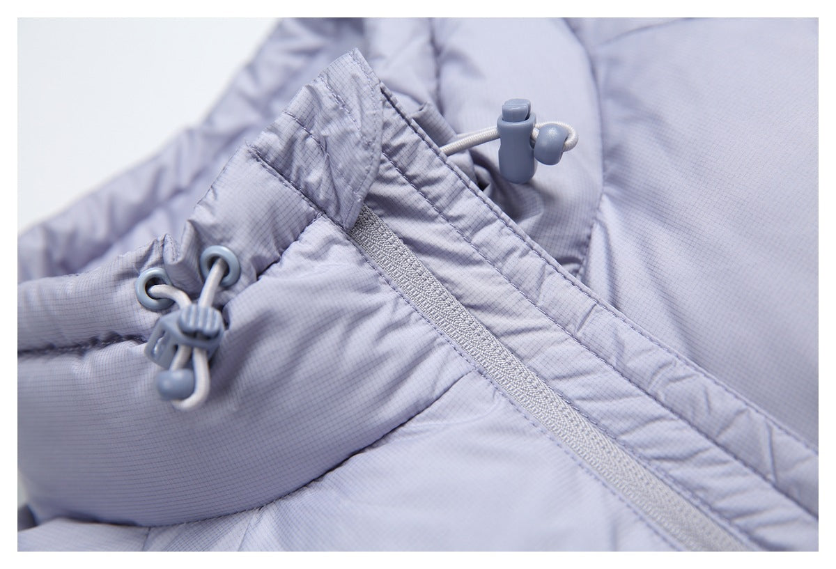 Close-up of a light lavender-gray garment with a zipper and adjustable drawcords.