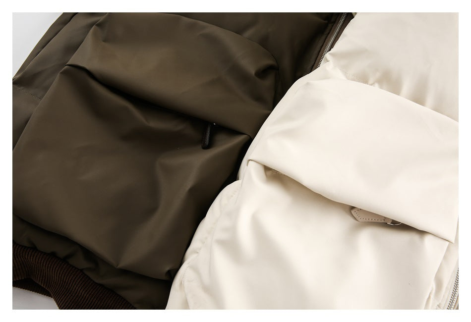 Close-up of large flap pockets on ivory and dark olive jackets, with ribbed trim visible.