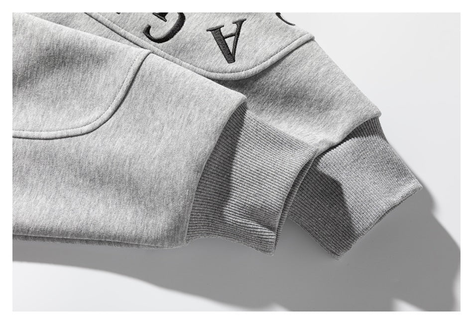 Close-up of a gray sweatshirt's ribbed cuffs and sleeve seams.