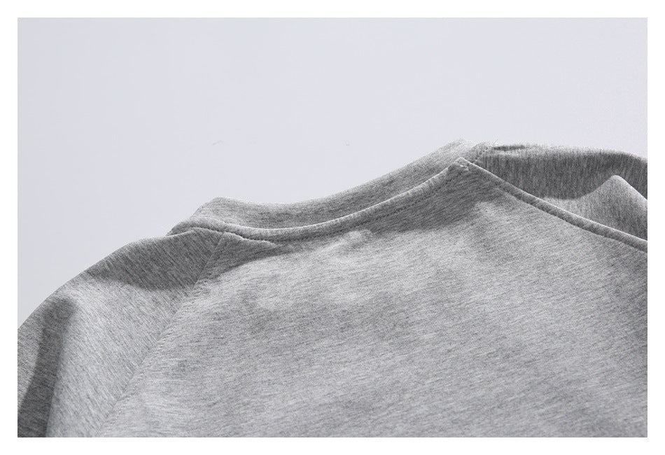 Close-up of the back neckline and shoulder seams on a heather gray sweatshirt.