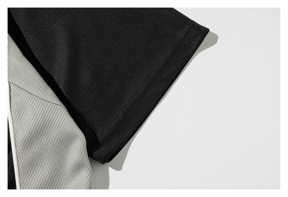 Close-up of a black jersey sleeve and its light gray side panel.