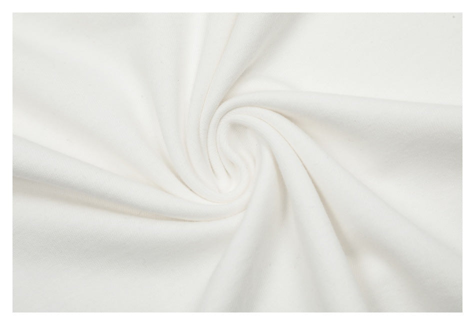 Close-up of soft-looking white fabric gathered into a spiral fold.