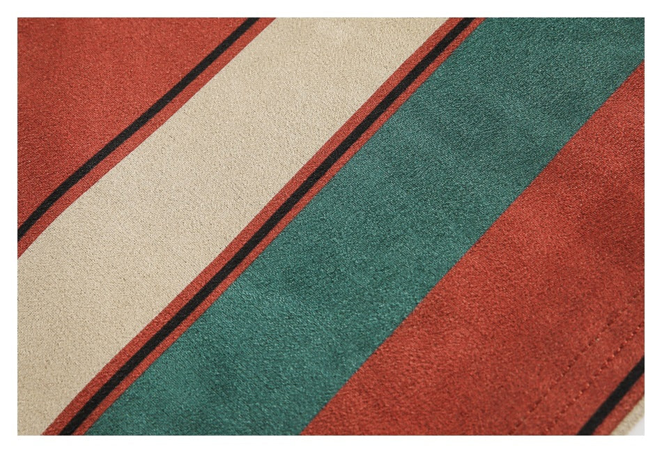 Close-up of diagonal beige, teal, and rust stripes with narrow dark borders.