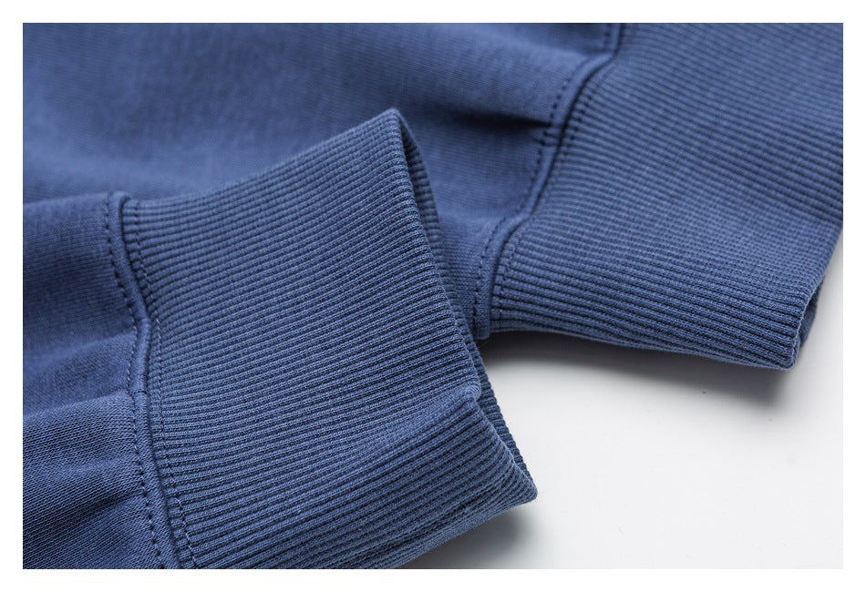 Close-up of ribbed blue sweatshirt cuffs and stitching.