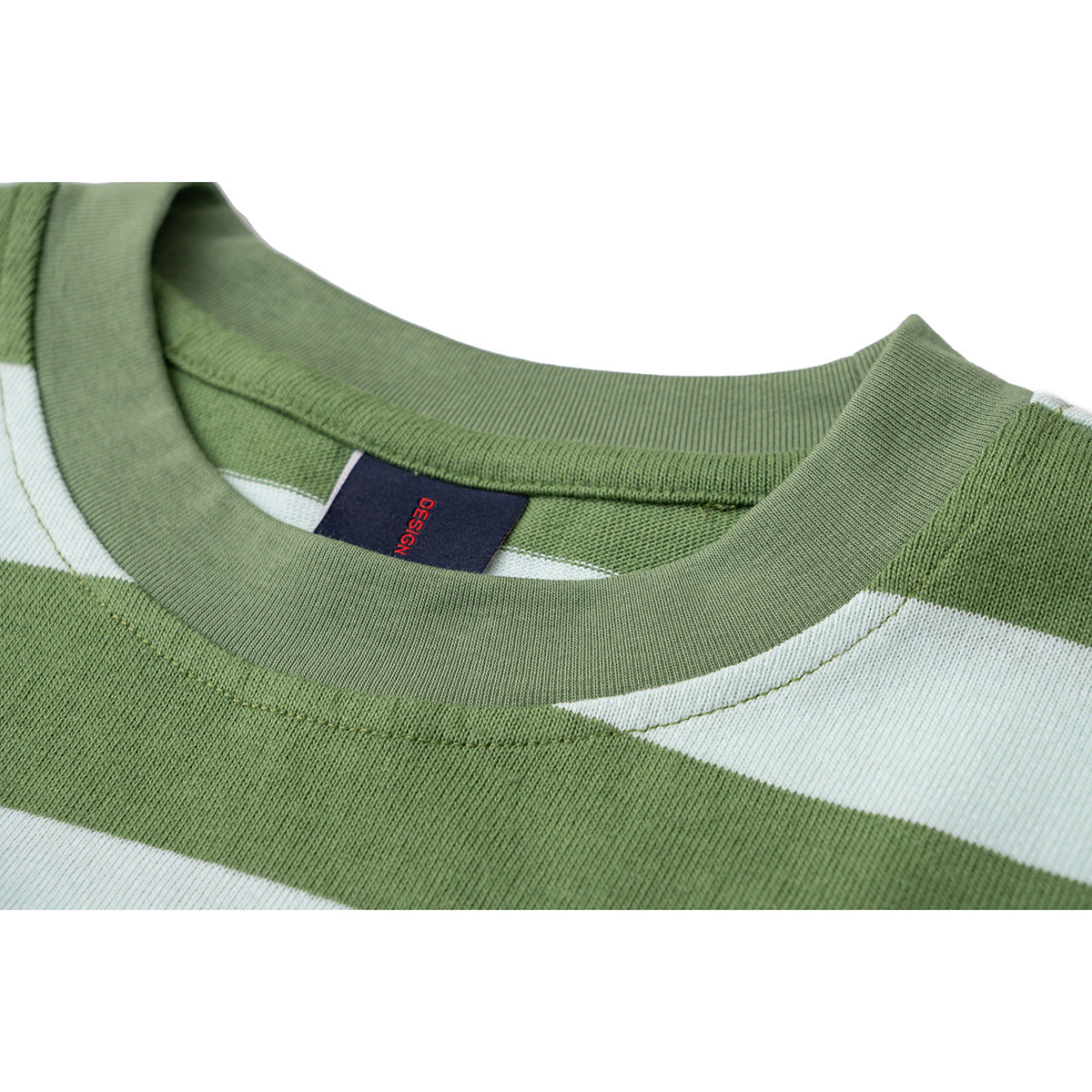Close-up of a green-and-white striped T-shirt's ribbed crew neck and inner label.