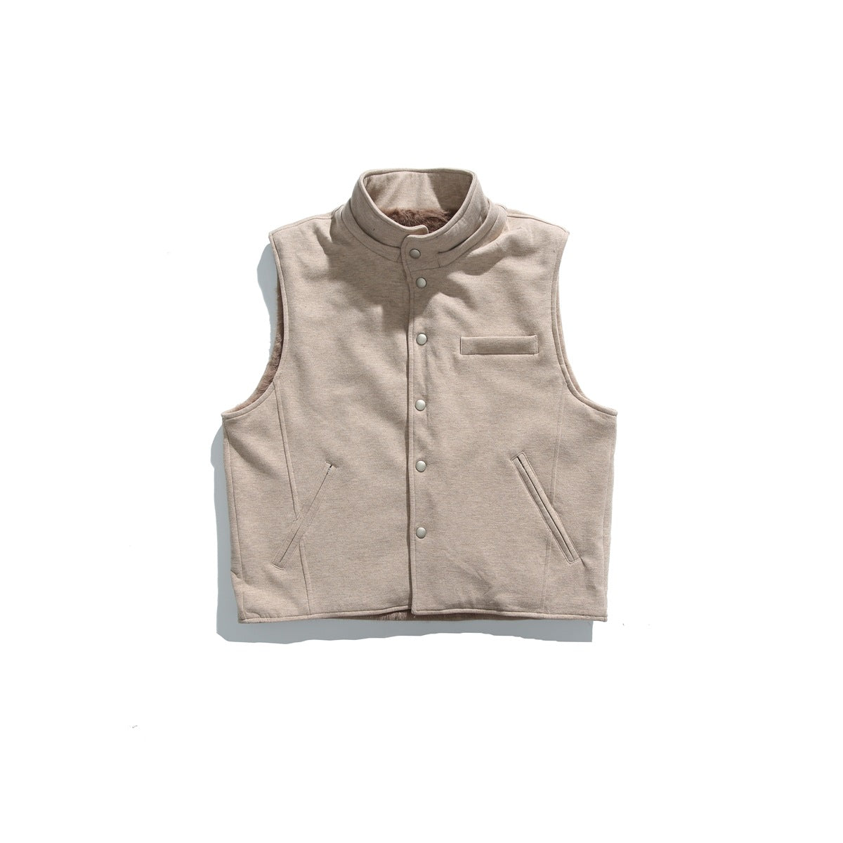 Front view of a light taupe sleeveless vest with a stand collar, snap-front closure, chest welt pocket and angled hand