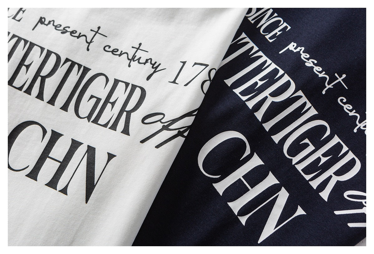 Close-up of white and dark navy garments with large black-and-white English text prints.