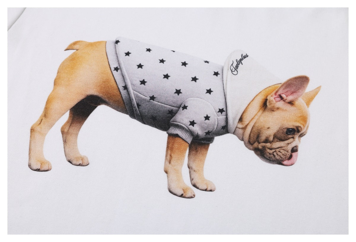 White T-shirt graphic of a tan dog wearing a gray outfit with black stars and a white cap.