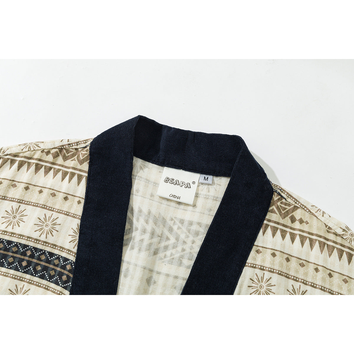 Close-up of a cream geometric-print shirt with a dark navy collar and visible neck label.