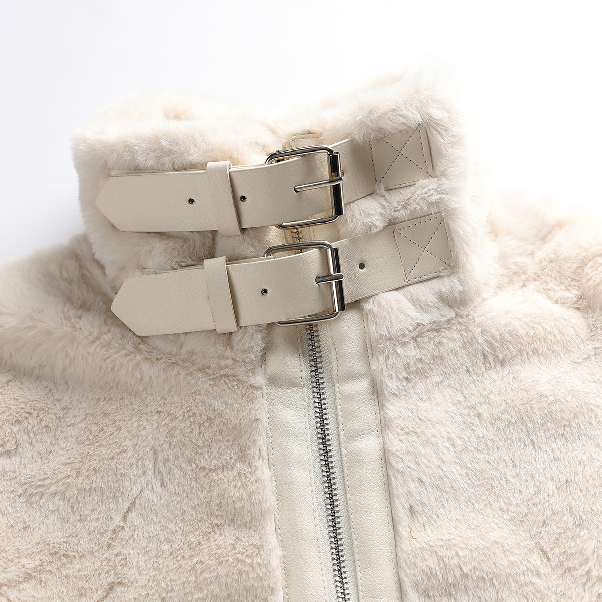 Close-up of an ivory faux-fur jacket collar with two adjustable buckle straps and a central zipper.