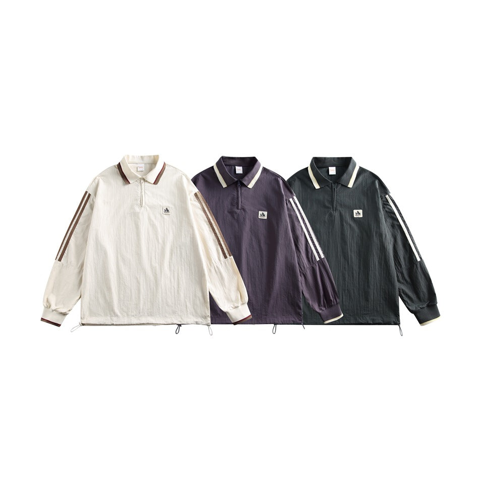 Three front views of the collared quarter-zip top in cream, dark purple, and deep green, each with sleeve stripes.