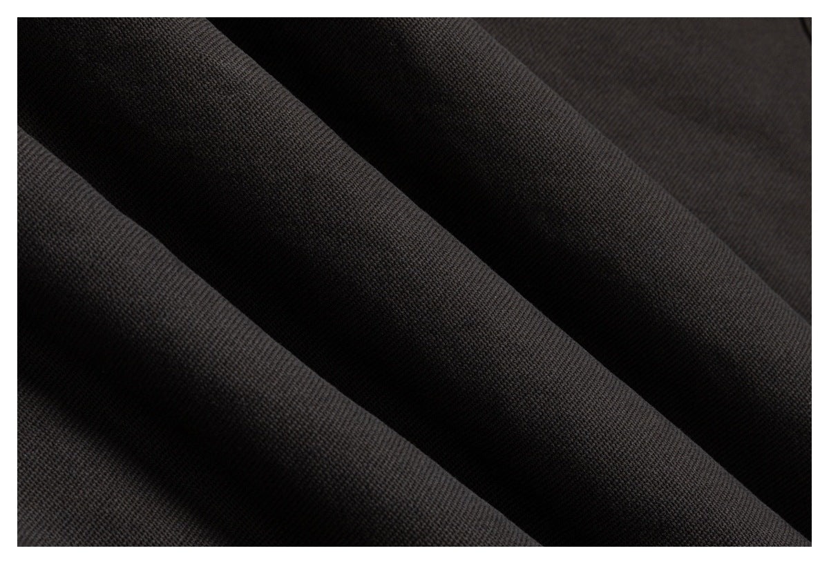 Close-up of dark charcoal-black fabric with a fine, tightly textured surface.