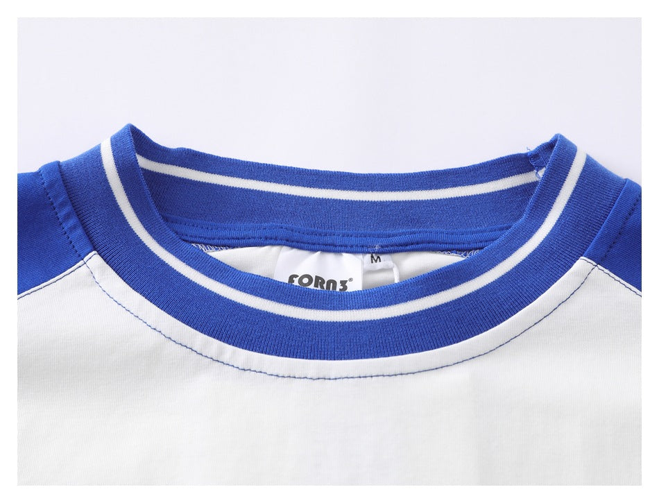 Close-up of the T-shirt's blue-and-white striped crew neck and inner brand label.